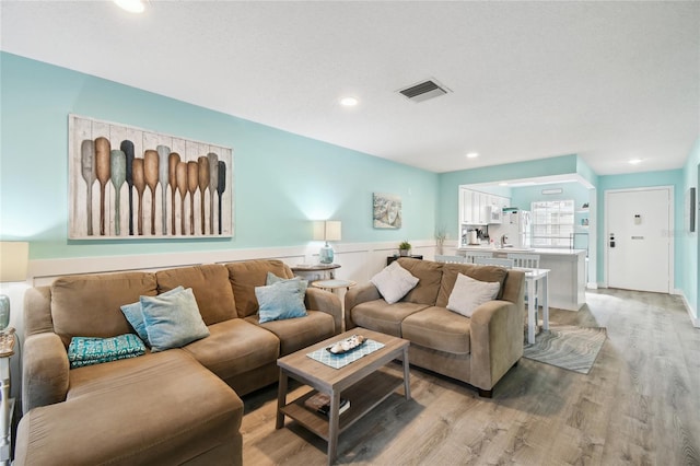 living room with light hardwood / wood-style flooring