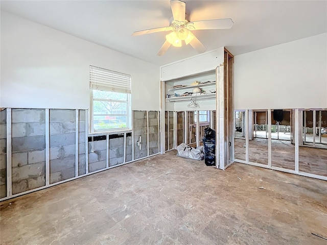 unfurnished living room with ceiling fan