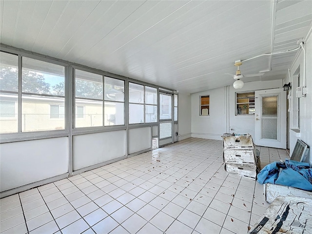 unfurnished sunroom featuring ceiling fan