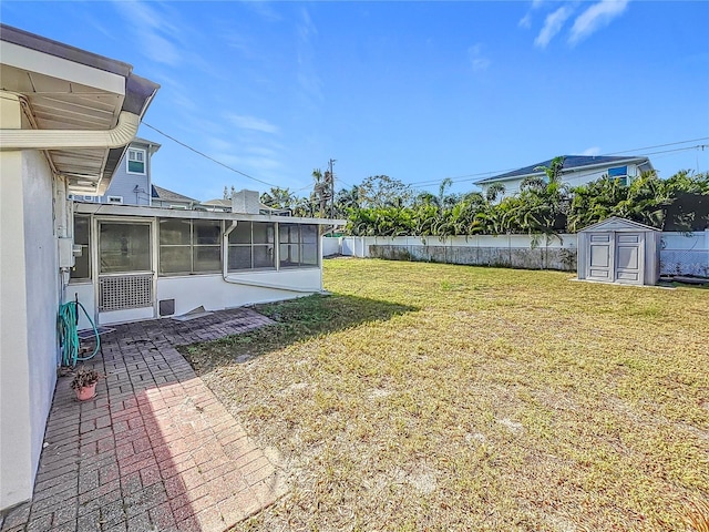 view of yard with a patio, a storage unit, and a sunroom