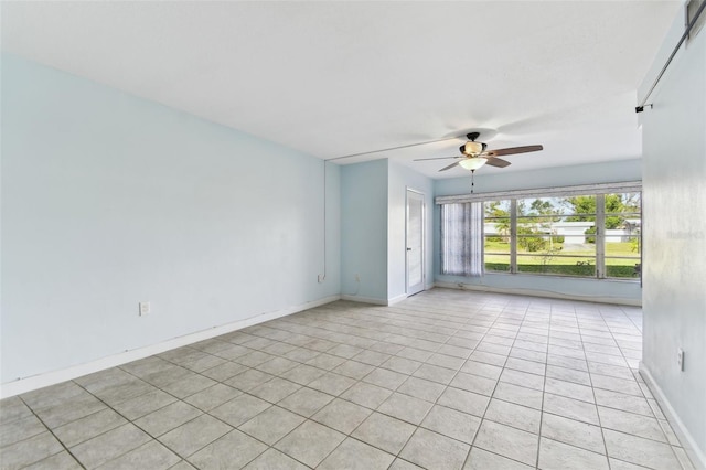 tiled spare room with ceiling fan