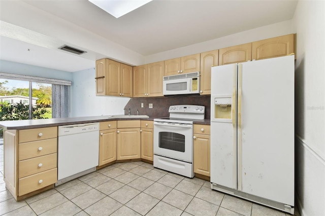 kitchen with decorative backsplash, light tile patterned flooring, white appliances, and light brown cabinetry