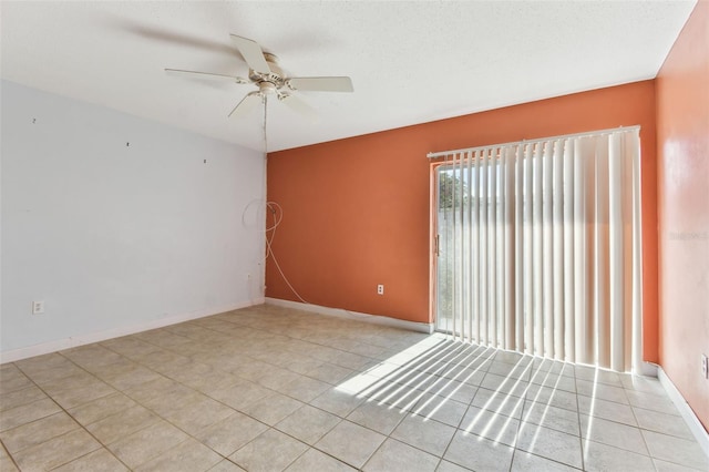 tiled empty room featuring a textured ceiling and ceiling fan