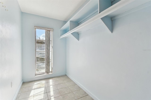 walk in closet featuring light tile patterned flooring