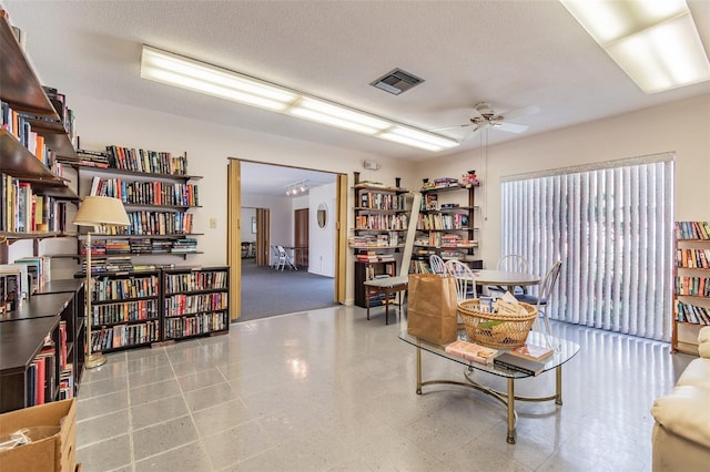 office with ceiling fan and a textured ceiling