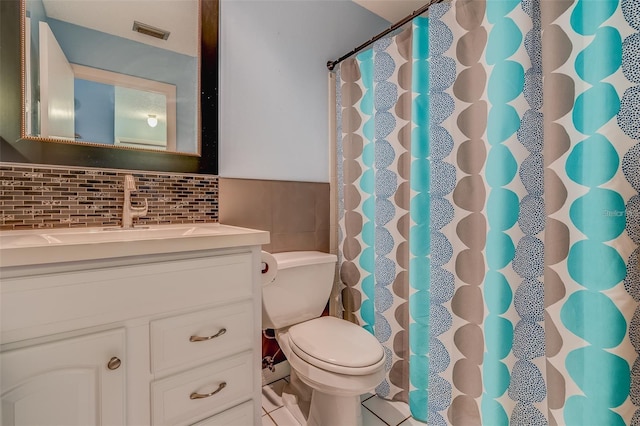 bathroom featuring vanity, tile patterned floors, toilet, tile walls, and tasteful backsplash