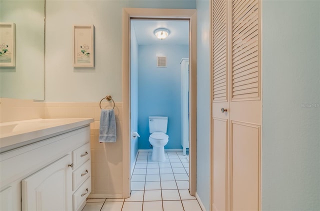 bathroom with tile patterned floors, vanity, and toilet