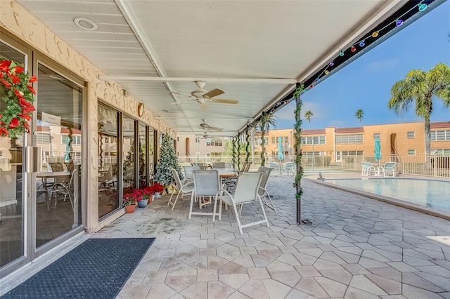 view of patio / terrace featuring ceiling fan and a community pool