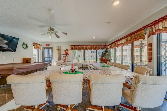 dining area featuring hardwood / wood-style floors, a textured ceiling, and ceiling fan