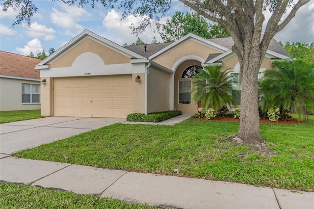 single story home with a front yard and a garage