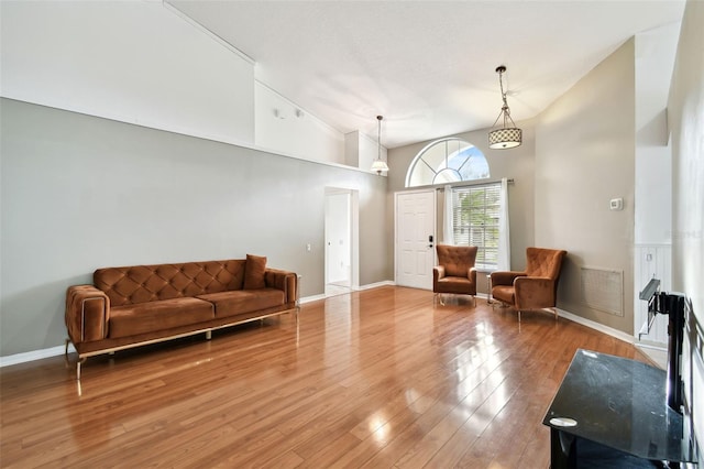 living room featuring hardwood / wood-style floors and high vaulted ceiling