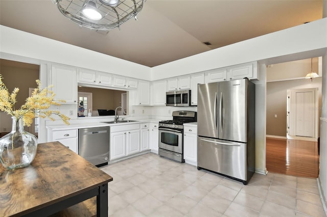 kitchen featuring white cabinets, appliances with stainless steel finishes, and sink