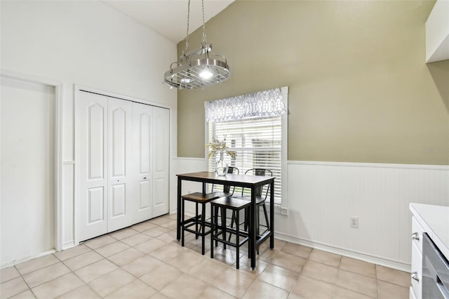 tiled dining space with lofted ceiling