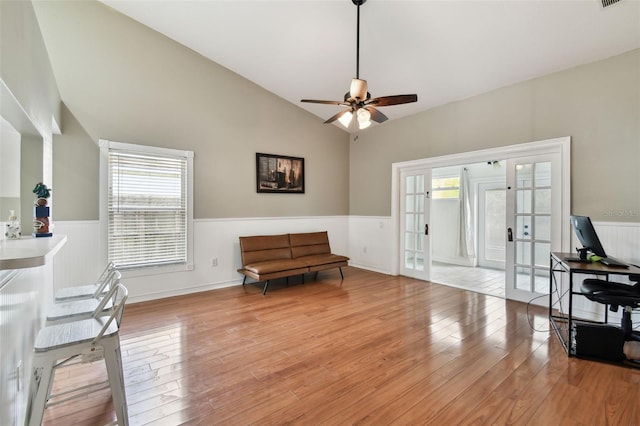 sitting room featuring ceiling fan, french doors, light hardwood / wood-style floors, and lofted ceiling