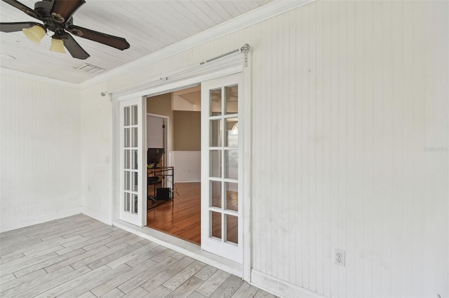 unfurnished sunroom with ceiling fan and french doors