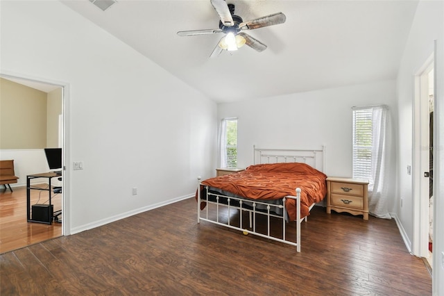 bedroom featuring ceiling fan, dark hardwood / wood-style flooring, and multiple windows