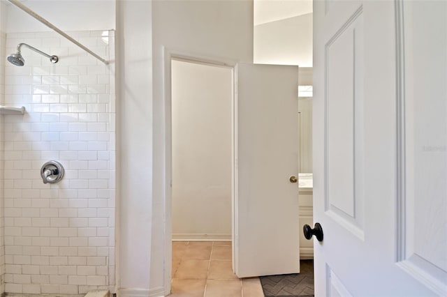 bathroom featuring a tile shower and tile patterned floors