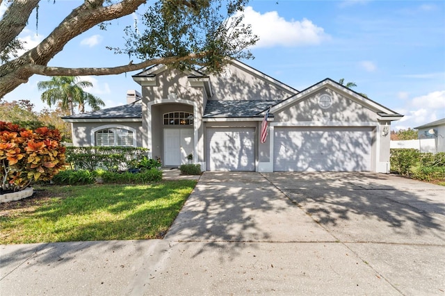 view of front of home with a garage and a front lawn