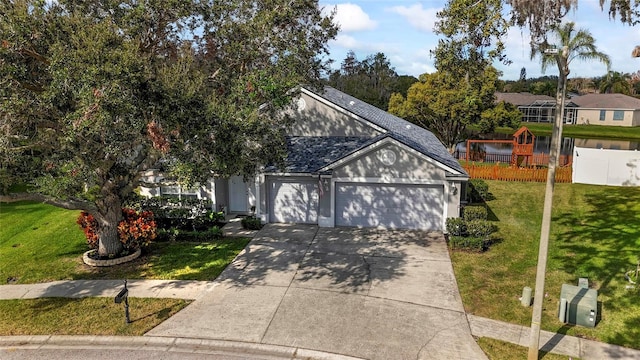 view of front of house with a garage and a front lawn