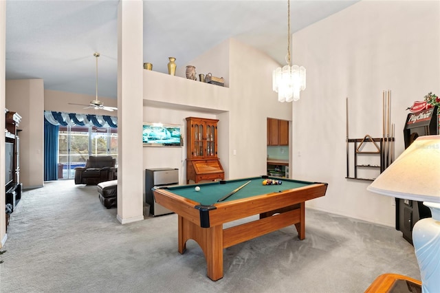 game room with high vaulted ceiling, ceiling fan with notable chandelier, light colored carpet, and pool table