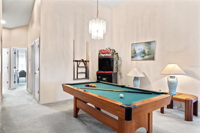 playroom with light colored carpet, a towering ceiling, pool table, and a chandelier