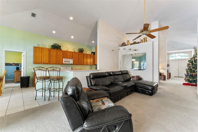 carpeted living room featuring ceiling fan and high vaulted ceiling