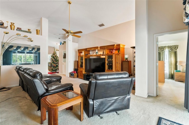 carpeted living room featuring a high ceiling and ceiling fan