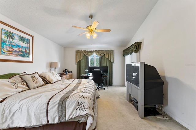 bedroom with a textured ceiling, ceiling fan, light carpet, and vaulted ceiling