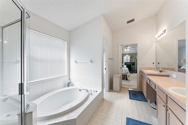 bathroom with vanity, ceiling fan, plus walk in shower, and vaulted ceiling