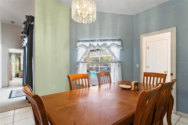 carpeted dining room featuring a chandelier