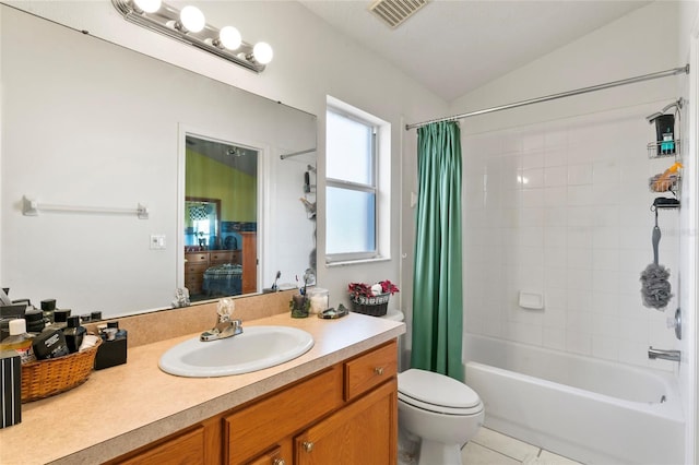 full bathroom with vanity, vaulted ceiling, shower / bath combo with shower curtain, tile patterned flooring, and toilet