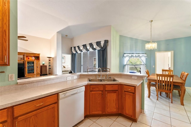 kitchen featuring kitchen peninsula, ceiling fan with notable chandelier, vaulted ceiling, sink, and dishwasher