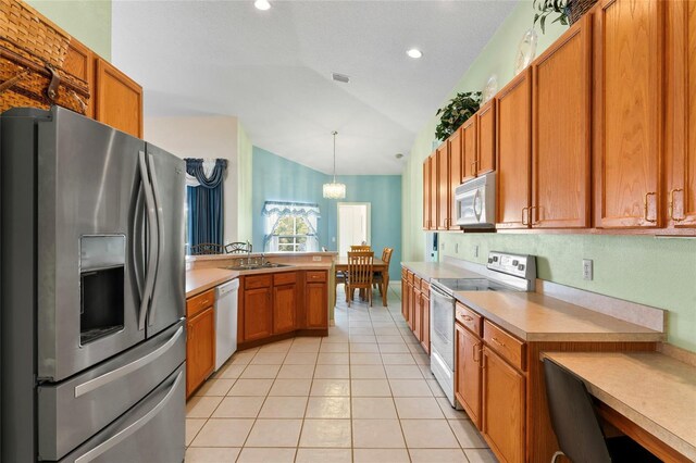 kitchen with a chandelier, vaulted ceiling, pendant lighting, white appliances, and light tile patterned flooring