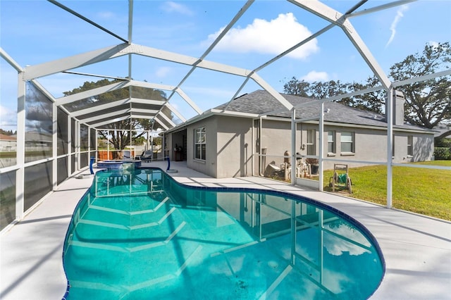 view of pool with a lanai, a patio area, and a lawn