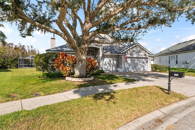 view of front facade with glass enclosure, a garage, and a front yard