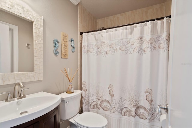 bathroom featuring curtained shower, vanity, and toilet