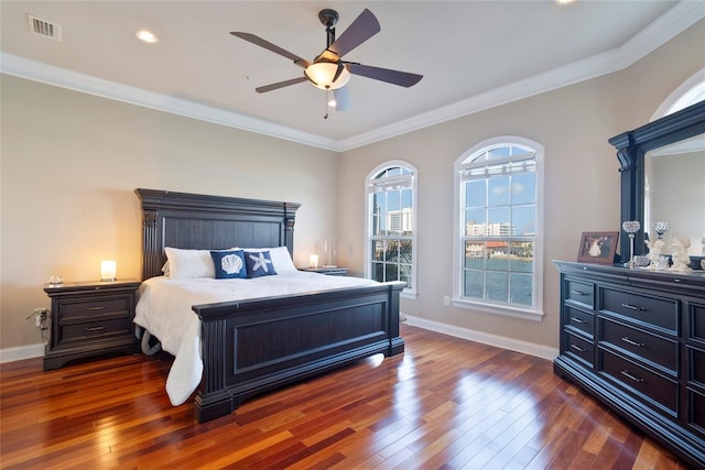 bedroom featuring baseboards, crown molding, visible vents, and dark wood-style flooring