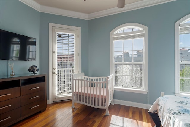 bedroom featuring ceiling fan, ornamental molding, and hardwood / wood-style floors