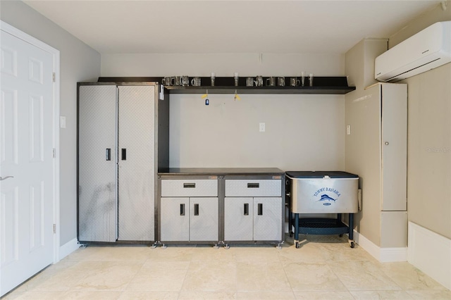 interior space with baseboards and a wall mounted AC