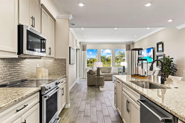 kitchen featuring dark hardwood / wood-style floors, sink, light stone counters, and stainless steel appliances