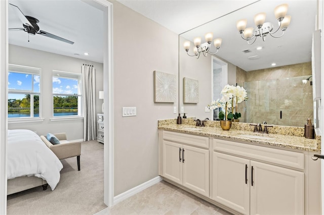 bathroom with tile patterned floors, ceiling fan with notable chandelier, a shower with door, and vanity