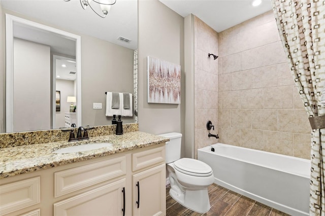 full bathroom featuring shower / bath combo with shower curtain, hardwood / wood-style floors, vanity, and toilet