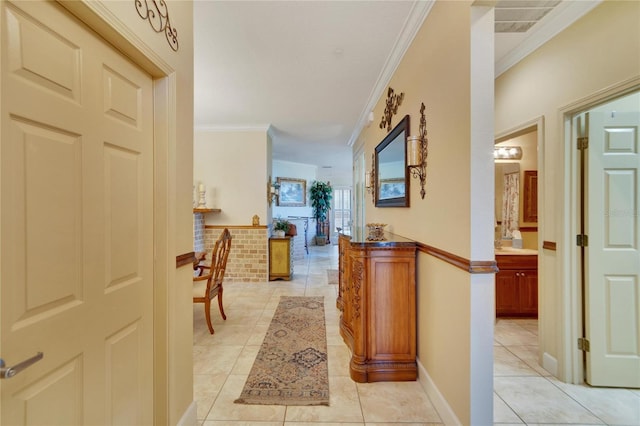 hallway with light tile patterned floors and ornamental molding