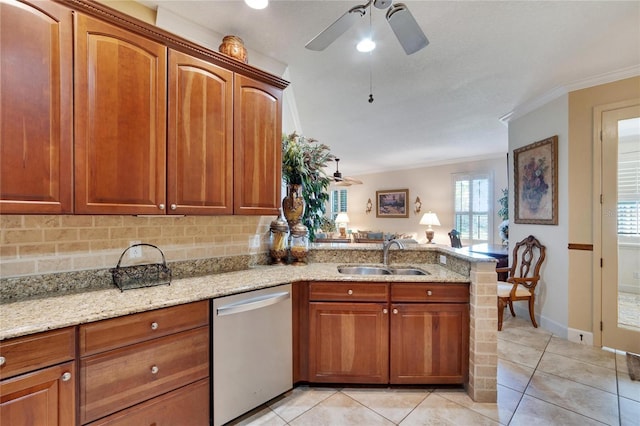 kitchen featuring sink, stainless steel dishwasher, light stone countertops, light tile patterned floors, and kitchen peninsula