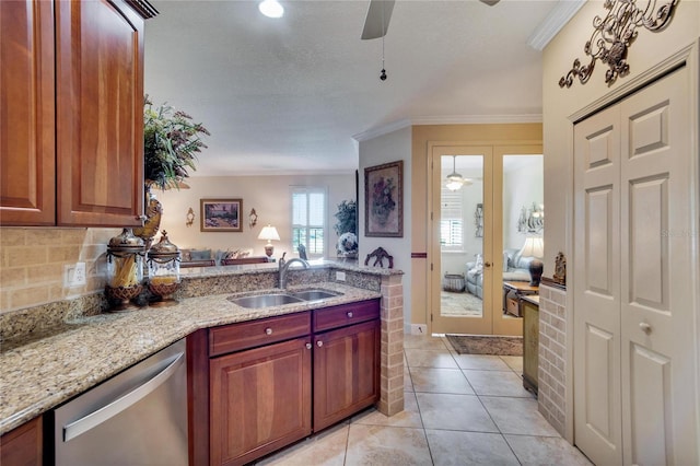 kitchen with dishwasher, sink, light stone counters, light tile patterned flooring, and ornamental molding