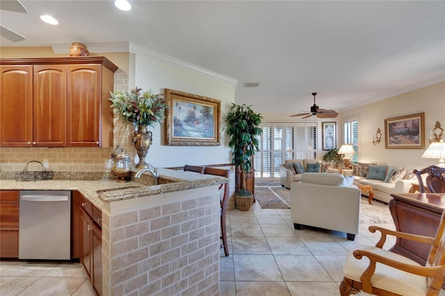 kitchen featuring dishwasher, light tile patterned floors, kitchen peninsula, and sink