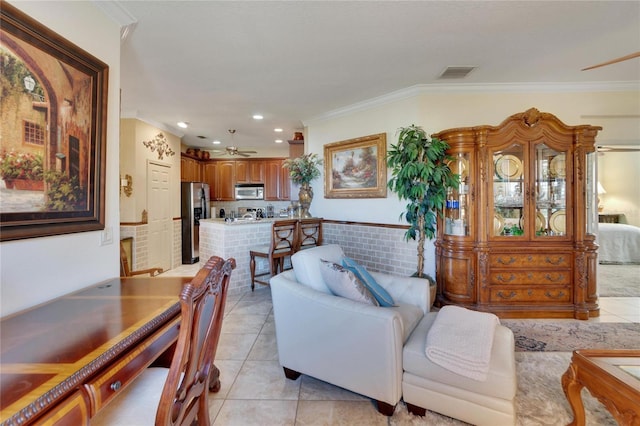 tiled living room featuring ceiling fan and crown molding