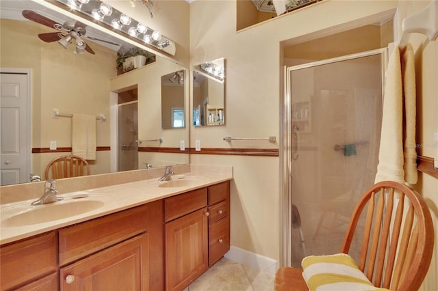 bathroom featuring tile patterned floors, ceiling fan, an enclosed shower, and vanity