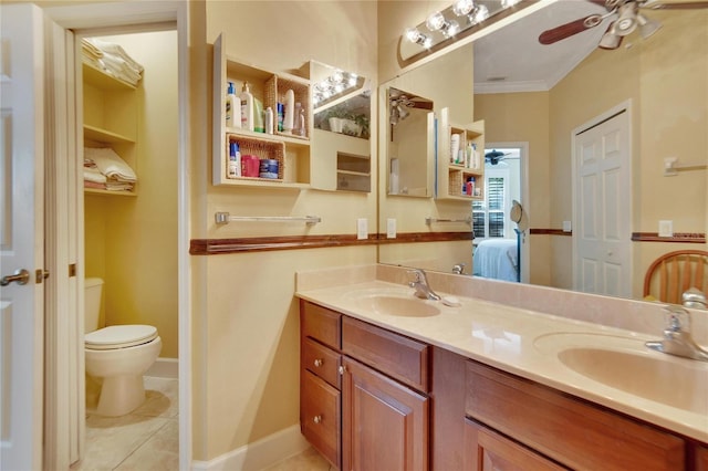 bathroom featuring ceiling fan, tile patterned flooring, toilet, vanity, and ornamental molding