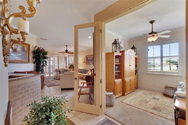 living room with light tile patterned floors, ceiling fan, and crown molding